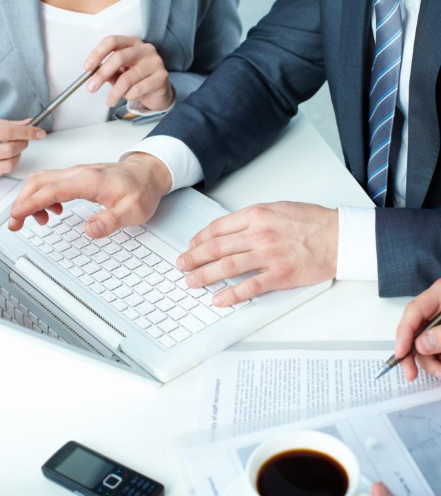 Group of business people working with laptop at meeting